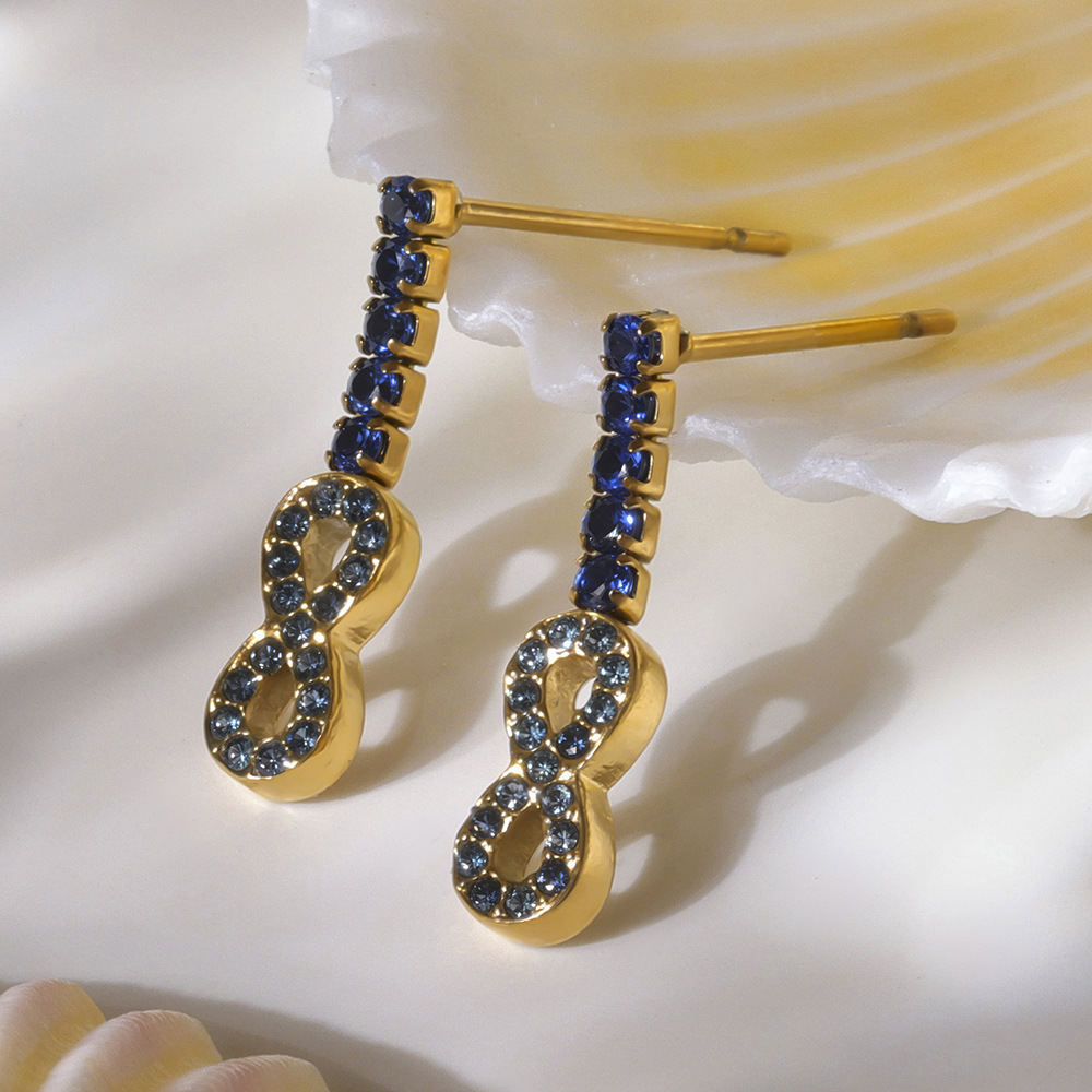 1 par de lujosos pendientes de botón de acero inoxidable con forma de infinito y circonitas doradas para mujer Imagen5