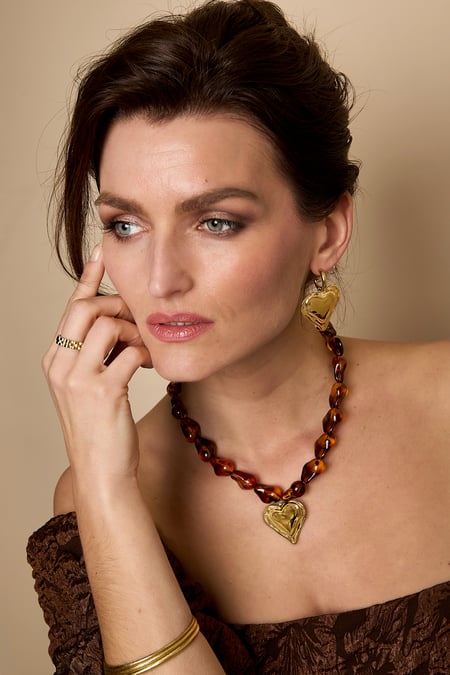 Beaded necklace with naturally shaped beads and a hanging heart