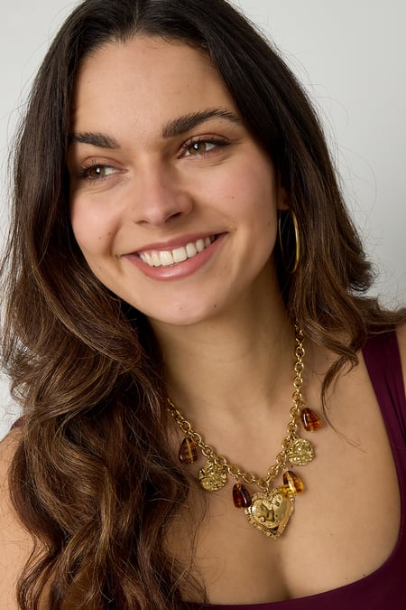 Gliederkette mit baumelnden Perlenmünzen und auffälligem Herz