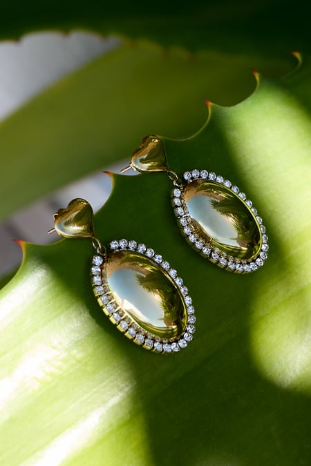 Boucles d'oreilles imposantes avec un pendentif ovale entouré de pierres