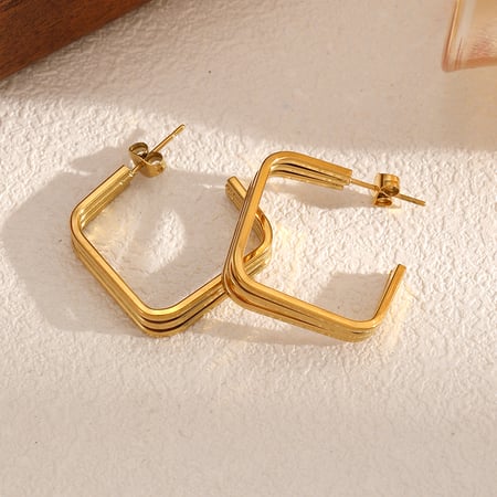 1 par de pendientes de botón de acero inoxidable de color dorado