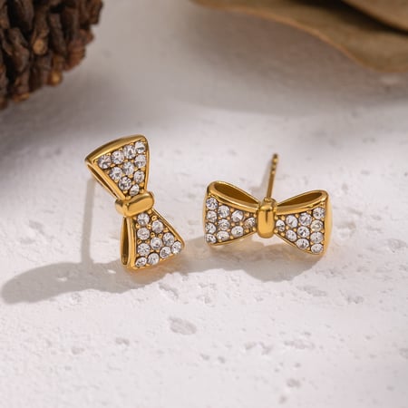 1 par de pendientes de botón de acero inoxidable con nudo de lazo en color dorado