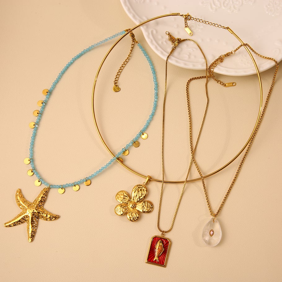 Collane con ciondolo a forma di stella marina oceanica in acciaio inossidabile color oro da donna Immagine4