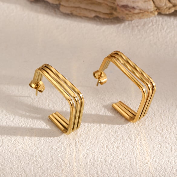1 par de pendientes de botón de acero inoxidable de color dorado