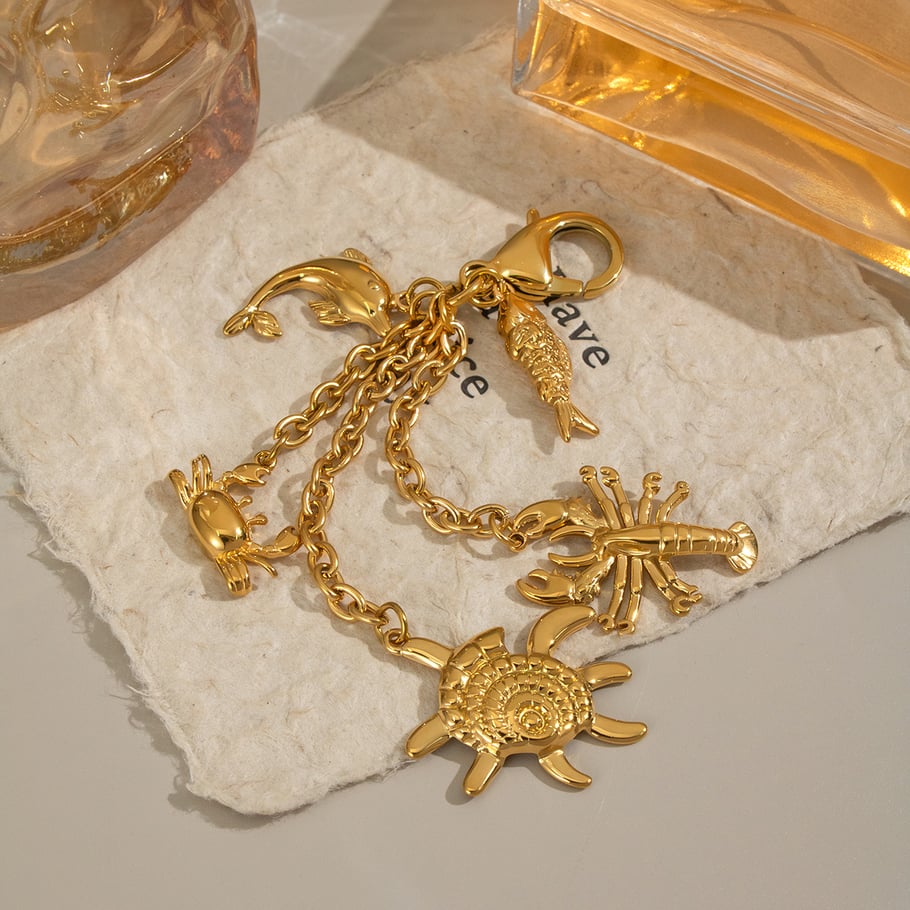 1 llavero de acero inoxidable oceánico color dorado. Imagen2