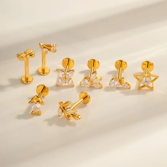 1 pezzo di orecchini da piercing da donna in lega di titanio con fiocco e stella marina color oro e zirconi 2